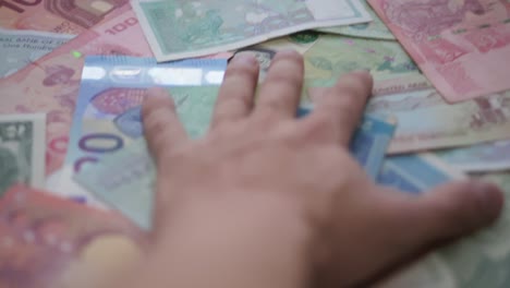 hand squeezes collection of money papers