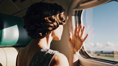 woman looking out airplane window