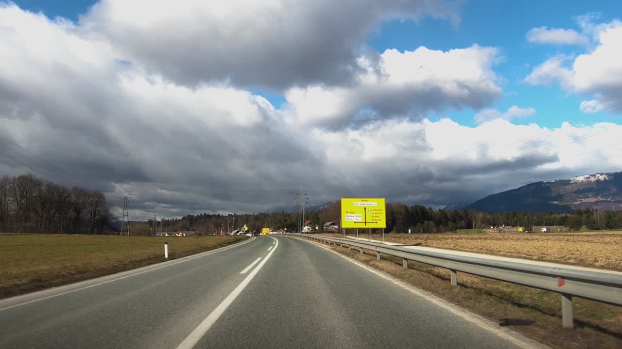 Dashboard point of view driving on Slovenia road from Kranj to Naklo on winter day