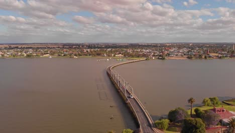 descending aerial view showing cars exiting the yarrawonga bridge from the nsw side