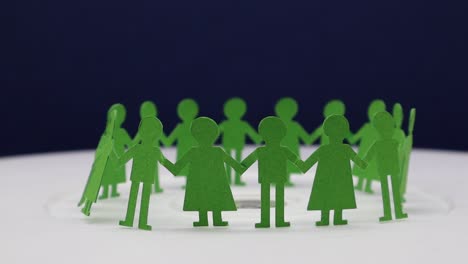 paper cut of children holding to each other for making a circular dance