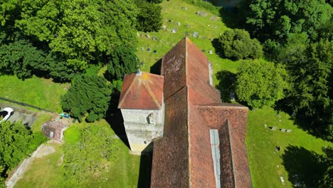 a top-down pan over st lawrence the martyr church in godmersham, panning over towards the graveyard