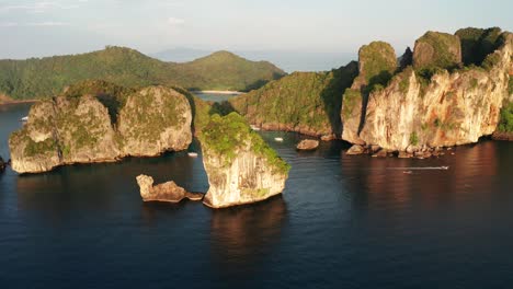 sunset drone shot of koh phi phi don and surrounding islands with nui beach and boats passing