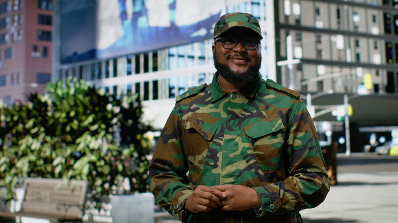 Confident african american soldier in uniform standing on a city street