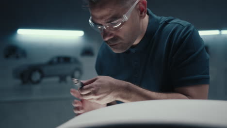 Automotive Technician Working on Car Interior Detail