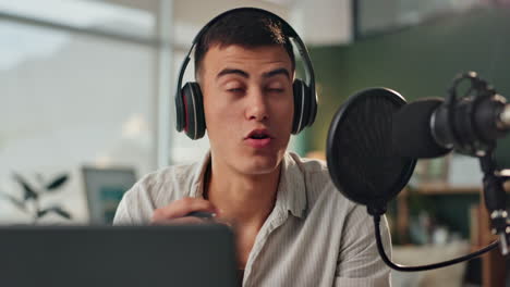 man recording podcast with microphone and headphones