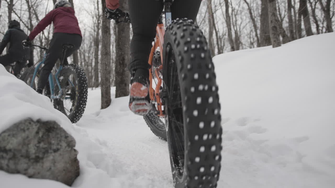 Friends riding fat bikes on a snow covered group ride