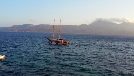 wooden ship tour in the greek mediterranean sea around milos island, drone scene