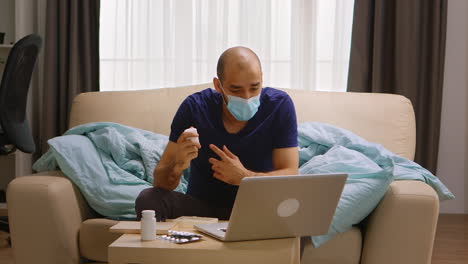 man wearing mask on a video call with his doctor