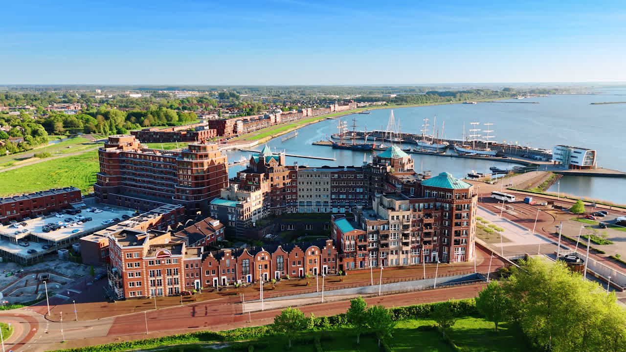 Amazing architectural complex at the shore of Lelystad, the Netherlands. Beautiful marina with sailing boats at backdrop. Aerial view.