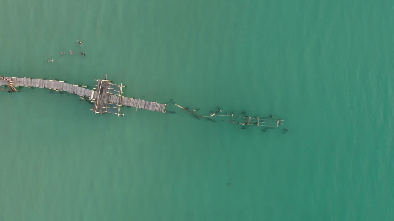 Aerial view of a wooden pier in the ocean