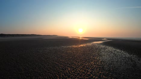 Aerial-above-the-beach-at-the-sunset