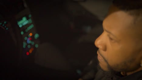 black-man-sitting-in-a-car-with-a-gun-and-an-angry-expression-contemplating-using-the-gun