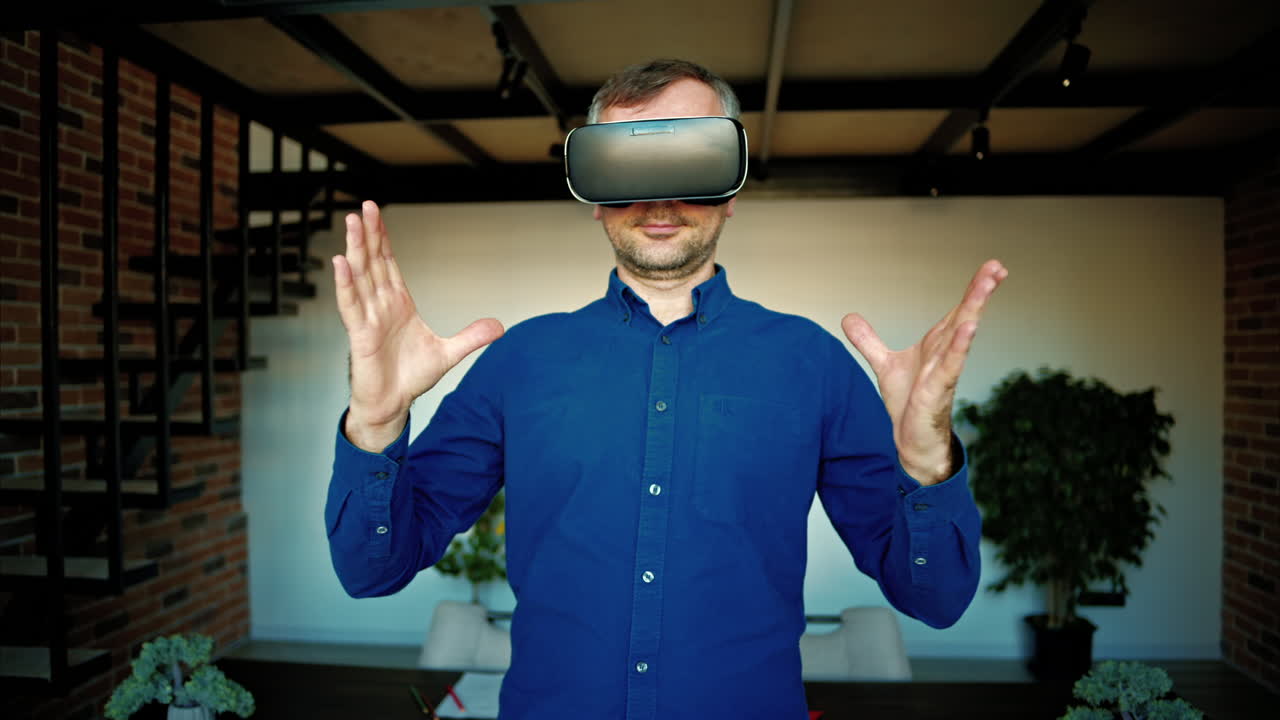 Man gesturing while using a Virtual Reality headset in an office