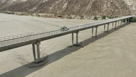 aerial view of truck driving on hingol river bridge