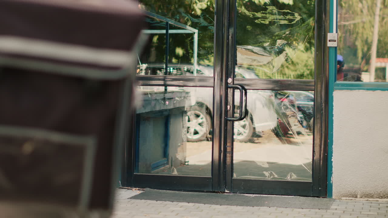 Food delivery person at a building entrance