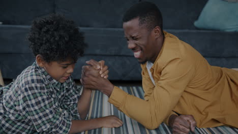 father and son arm wrestling