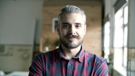 front view of cheerful smiling young man with grey hair