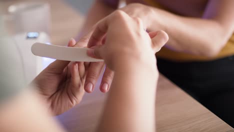 tilt up video of woman during doing manicure