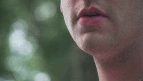 close up of male model smoking vaporizer outside