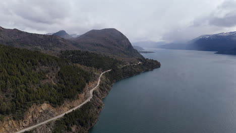 aerial view of scenic lake and mountain road