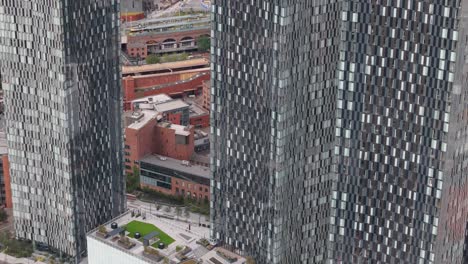 manchester deansgate aerial view descending modern city centre skyscraper development in the business district