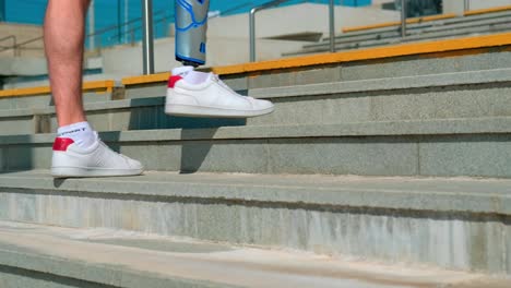 person with prosthetic leg walking up stairs