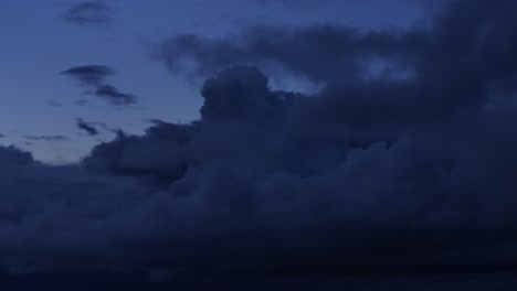 the last of blue light illuminates the dark moody skies at sunset