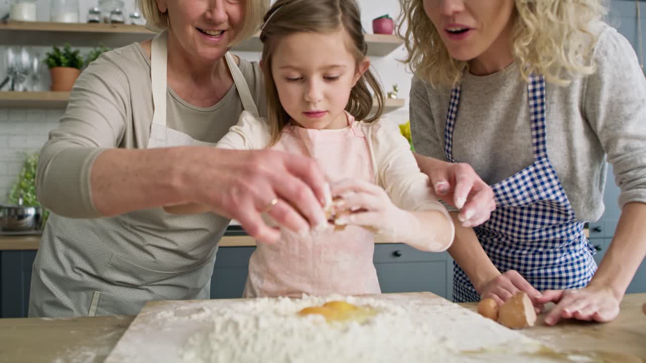 Video of grandmother helping girl to easter bake