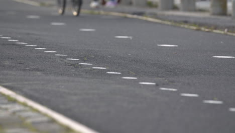 A-walk-with-people-running-and-cycling-near-the-Tejo's-River-and-the-25Th-April-Bridge