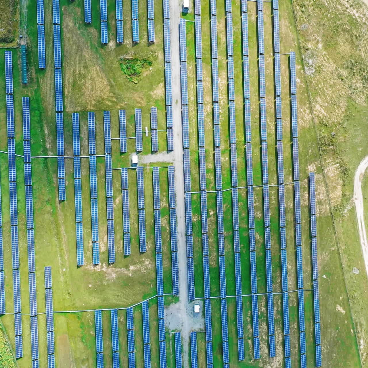 Ecological power plant in summer. Top view on the solar panels on the field. Renewable energy. Alternative source of electricity. Aerial view. Camera moves around.