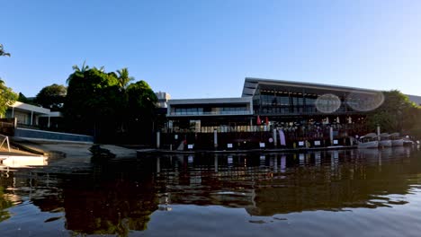 modern building by water with clear sky