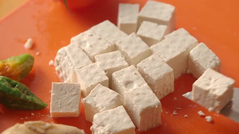 cubed tofu and vegetables on a cutting board