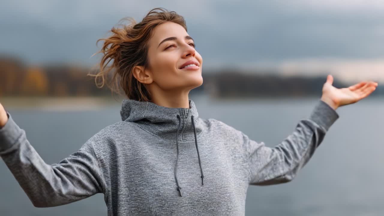 A Blissful Moment of Serenity by the Water: A Young Woman Enjoying Nature's Beauty and Embracing Peaceful Relaxation Amidst Calm Waters and Cloudy Skies