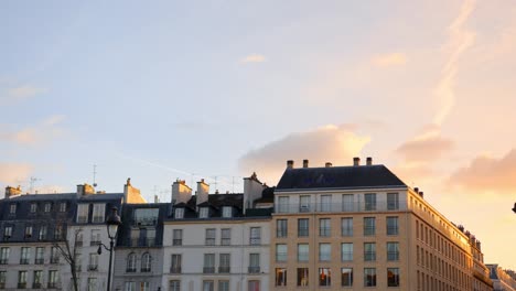 a view of typical french architecture in paris, france during sunset