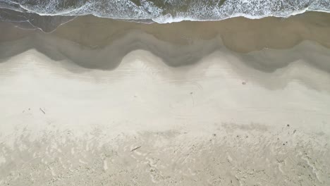 waves, beach, sand and water movement on a deserted beach