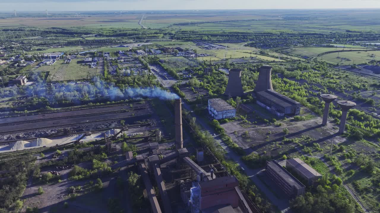 Metal recycling plant, drone push-in tilt-down shot