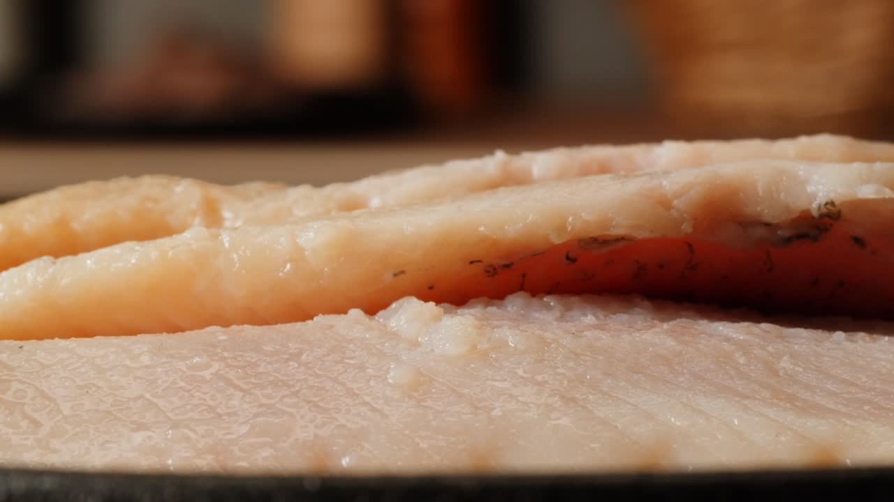 Raw fish fillets in a pan
