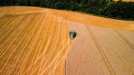 aerial view of a combine working in a farmland