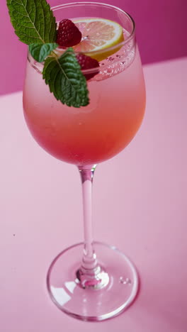 refreshing pink drink with raspberries, lemon, and mint