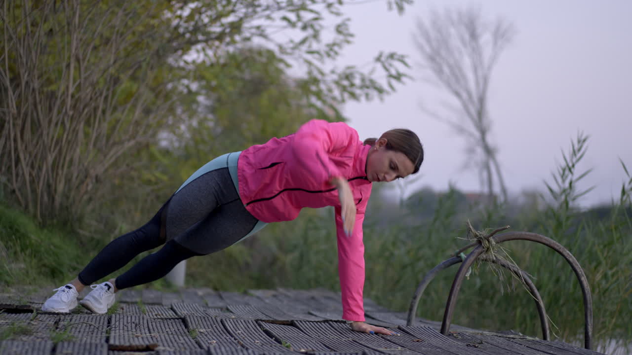 Woman performing fitness exercises and yoga poses outdoors