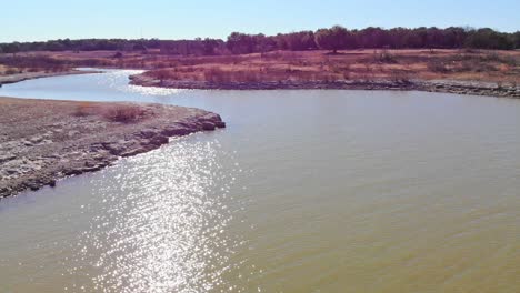 flying low near water, circling left deeper into a cove