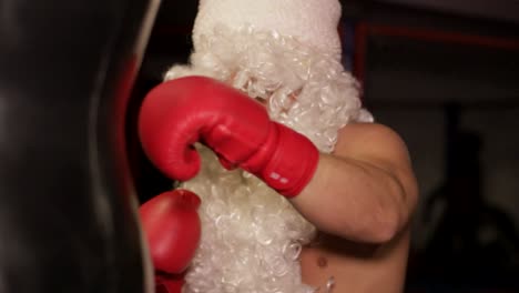 Santa Claus Beats Boxing Bag Angry Santa Claus Santa Claus Kickboxer Training in the Gym the Concept of Sport