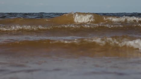 gentle sea waves wash over the sandy shore, creating a peaceful and calming interaction between water and land