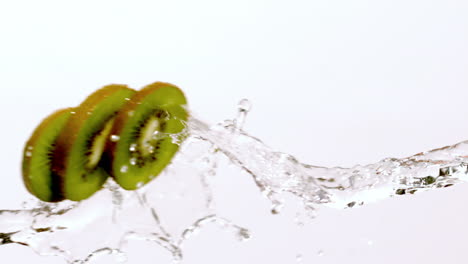 kiwi slices moving through stream of water