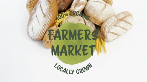 animation of 100 percent farmers market locally grown text banner over close up of variety of bread