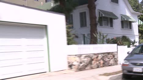 a car travels along a street in santa monica california as seen through the rear window at an angle 7