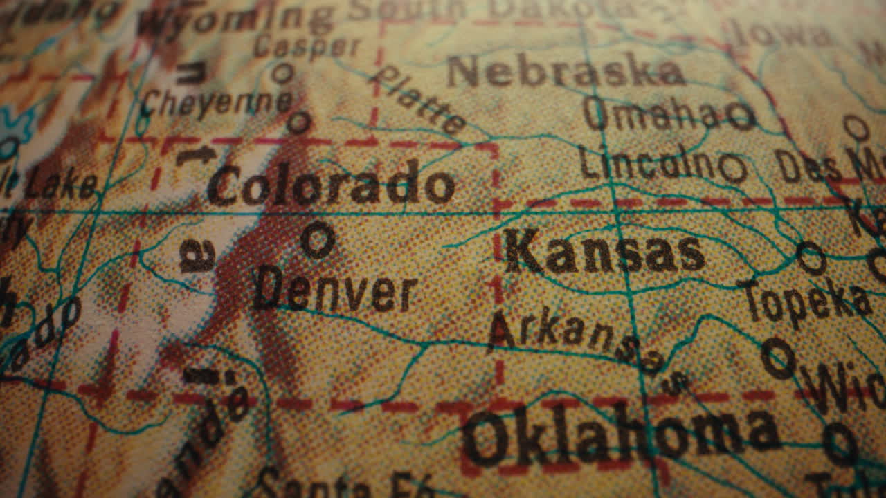 Close-up of a vintage world map featuring the states of Colorado and Kansas.