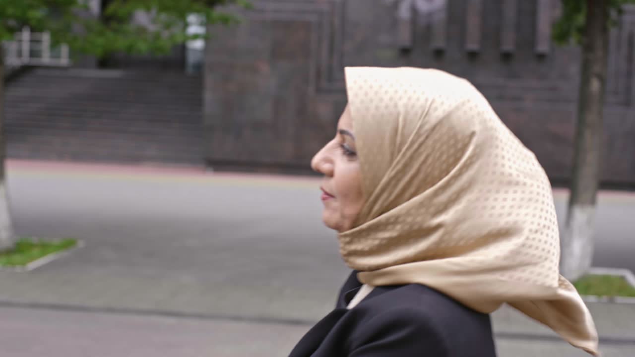 Middle Eastern lady walking down street