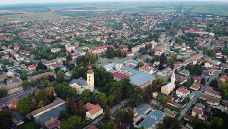 Panorama of a small town with drone's point of view at sunset, the church is in focus.
